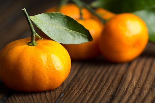 Juicy ripe tangerines on a wooden table