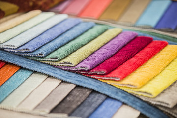 The perspective of the palette of fabrics. Colorful upholstery fabric samples