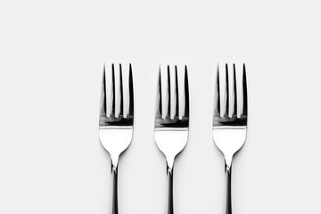 Fork and spoon in white background / A fork, in cutlery or kitchenware , Spoons are used primarily for eating liquid or semi-liquid foods