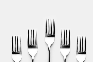 Fork and spoon in white background / A fork, in cutlery or kitchenware , Spoons are used primarily for eating liquid or semi-liquid foods