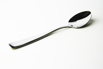 Fork and spoon in white background / A fork, in cutlery or kitchenware , Spoons are used primarily for eating liquid or semi-liquid foods