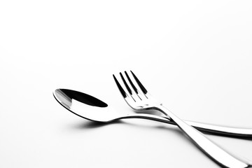 Fork and spoon in white background / A fork, in cutlery or kitchenware , Spoons are used primarily...