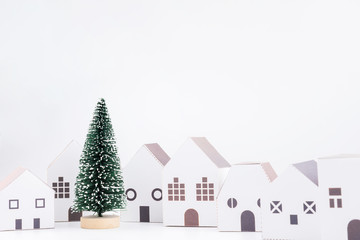 Christmas tree in the paper house town isolated on white background with copy space.Christmas day concept.