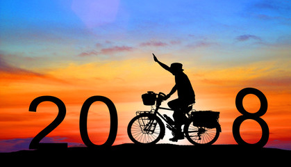 Obraz premium silhouette man driving with a bicycle,Happy new year 2018 concept.