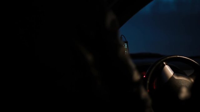 POV Female driver getting in a car at night. Female face reflecting in side mirror. Before a long trip with gps map.