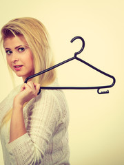 Woman holding clothes hanger