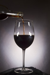 Wine is poured from the bottle into the glass