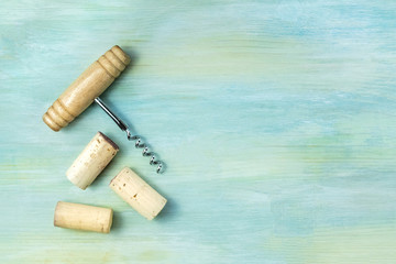 Vintage corks and corkscrew on teal with copy space