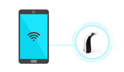Mini behind the ear hearing aids connected to a smartphone via wireless connection.