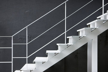 white iron stair with black wall.