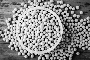 Soybean in wood bowl on wooden background.