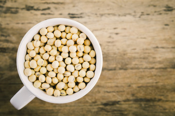 Soybeans on old wood background.