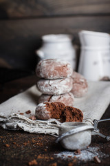 Deliciouse Homemade Chocolate crinkle cookies with powdered sugar icing on dark stone table background. Copy space