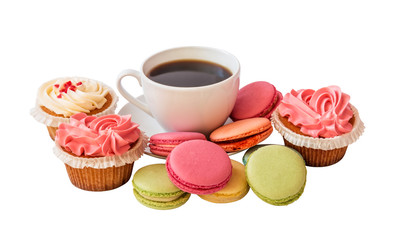 White coffee cup with colorful macarons and cupcakes isolated on white background. Selective focus