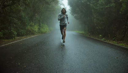 Handsome jogger running in the exotic area © majdansky