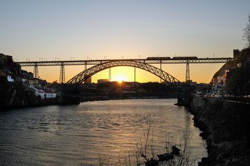 View on amazing sunset at Dom Luis I bridge, Porto. Portugal