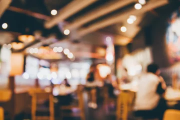 Zelfklevend Fotobehang Restaurant cafe or coffee shop interior with people abstract blur background © Piman Khrutmuang