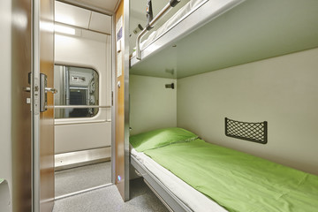 Train berth corridor indoor with two beds. Travel background.