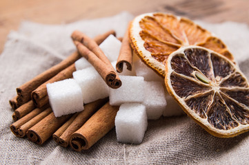 Fototapeta na wymiar Dried orange with sugar and cinnamon on a wooden table