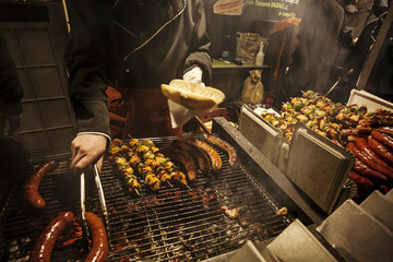 Meat sausages and skewers on barbecue grill.