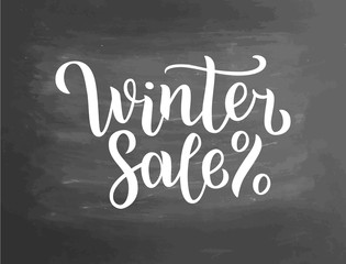 Winter sale lettering on blackboard. Winter sale text lettering for invitation and greeting card, prints and posters. Hand drawn typographic inscriptions. Vector illustration