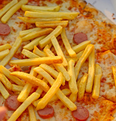 fries over the tasty pizza with wurstel mozzarella and tomato