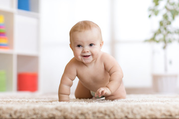 adorable baby crawling on fluffy carpet at home