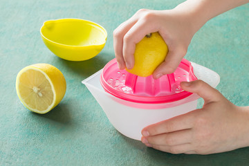Squeeze lemon juice with handheld juicer