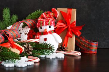 New Year background with gifts, sweets and a snowman. Happy New Year and Merry Christmas.