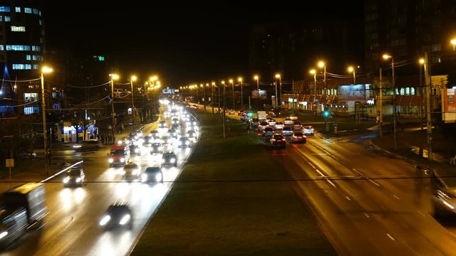 Night traffic in city. Timelapse. Night scenery of highway with transportation traffic in night downtown, time lapse.
