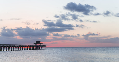 Fototapeta premium pier jetty at sunset in Naples, forida, usa