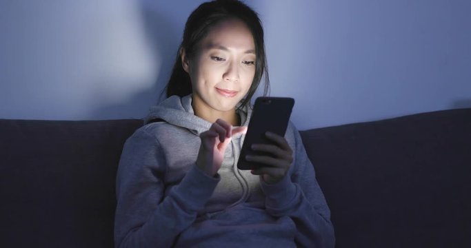 Woman look at smart phone at home