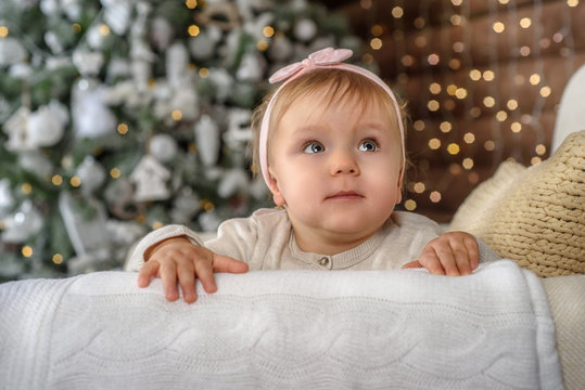 Happy baby girl under the Christmas tree home