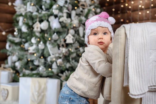 Happy baby girl under the Christmas tree home