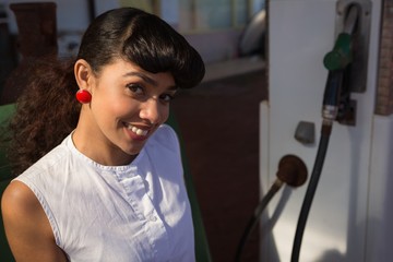 Portrait of woman relaxing at petrol pump station