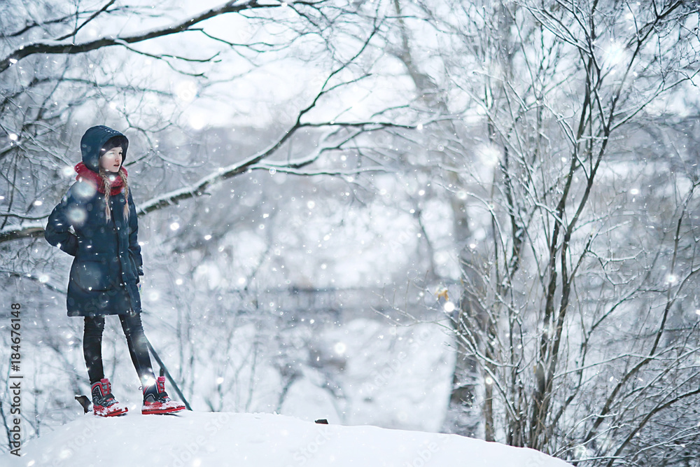 Poster girl in winter for a walk in the park / seasonal photo of a child in warm clothes. Winter landscape with a child. Walk frost, urban style, upbringing,, christmas vacation