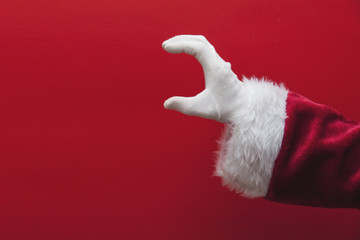Santa Claus hand against a red background