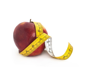 Red apple and measuring tape on a white background