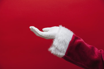 Santa Claus empty hand against a red background