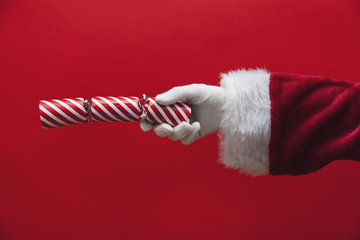 Santa Claus hand holding a Christmas cracker