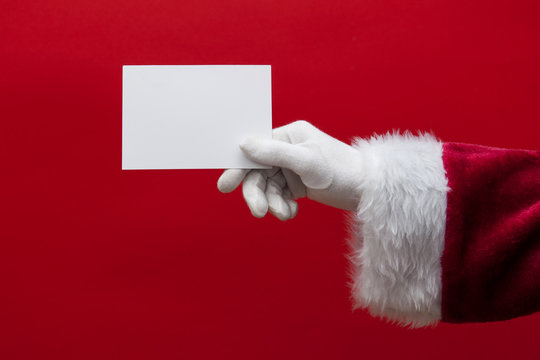 Santa Claus hand holding a blank white sign