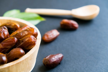 closeup sweet dried date palm fruits or kurma, ramadan (ramazan) food. Natural light. Selective focus. Close up on a black background. Top view, flat lay. copy space