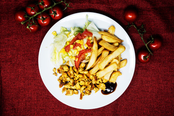 Fresh chicken steak with tomatoes and french fries