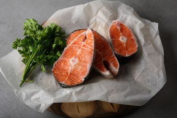 Raw fish salmon steaks with greens