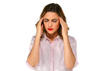 Fototapeta premium Pretty woman sufferring headache with closed eyes and holds her hands on temples. Isolated on white background.