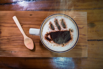 Cup of coffee on wooden dable in the coffee shop.