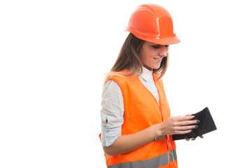 Happy young constructor counting her money