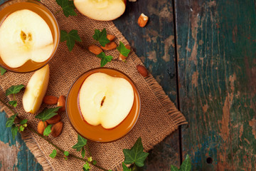 Hot drink of apple tea with cinnamon stick. Hot drink with apples for autumn or winter.