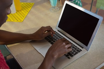 Man using laptop in the restaurant