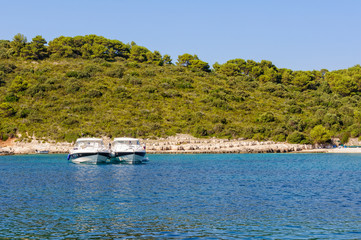 Two yachts anchored side by side in the beautiful  Milne Bay - Hvar, Croatia